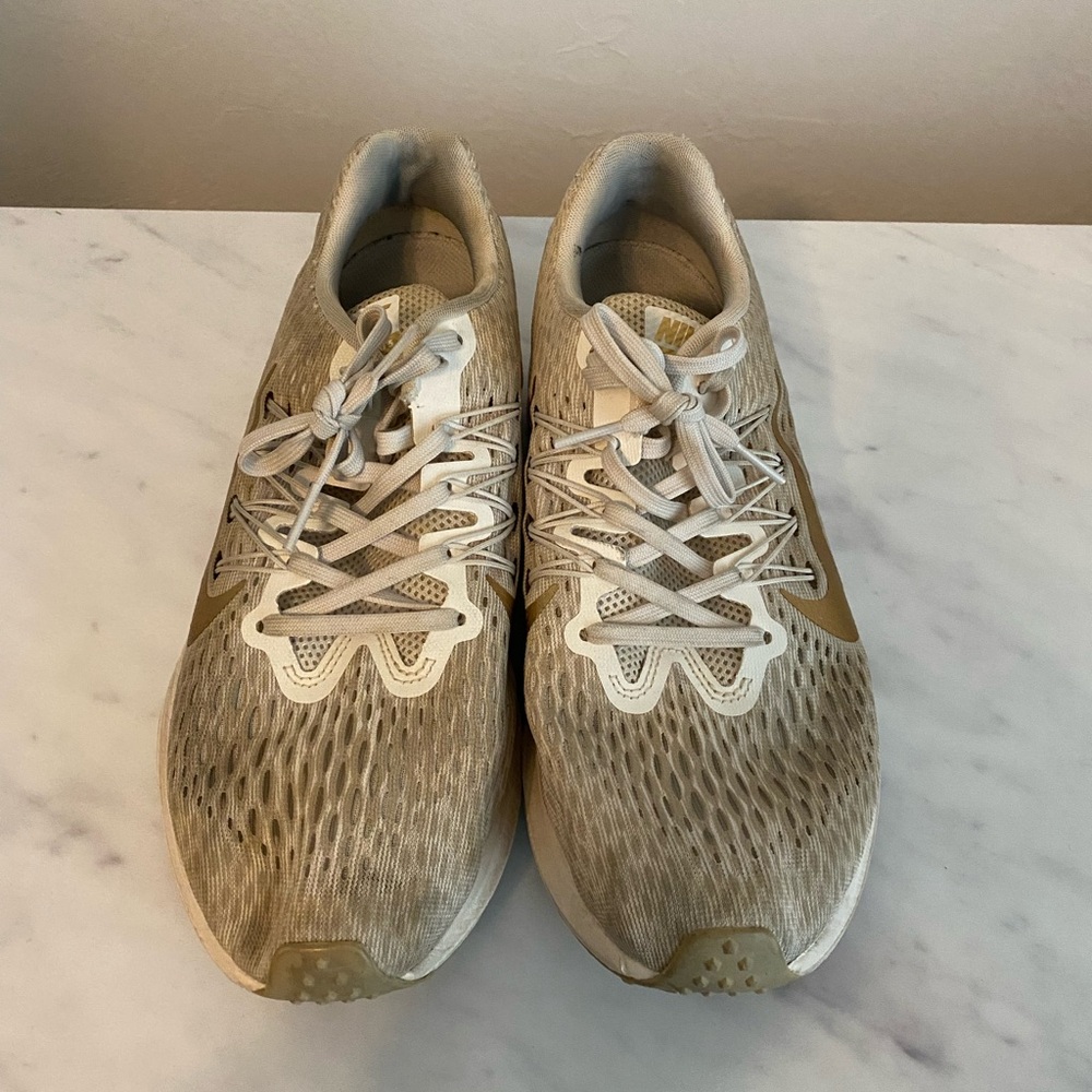 Gold Nike tennis shoes